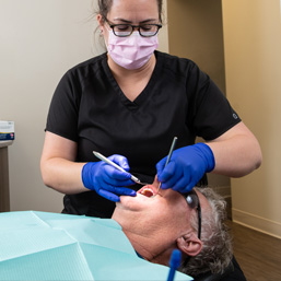 Dentist with patient in chair